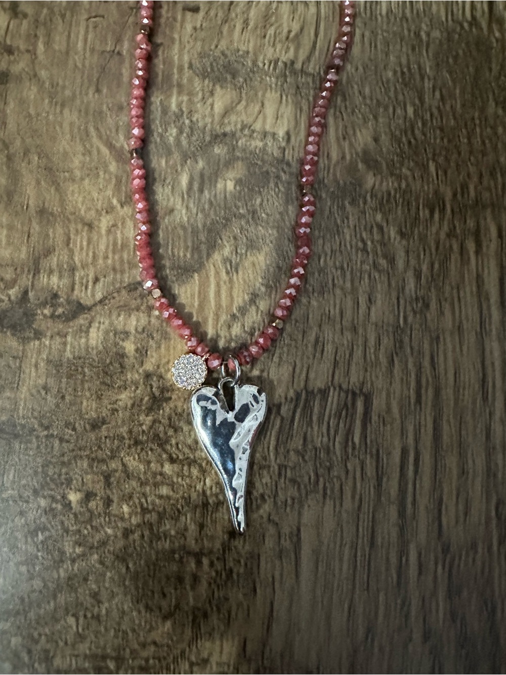 Pink Panache pink beaded necklace with a silver heart and gold circle charm. .